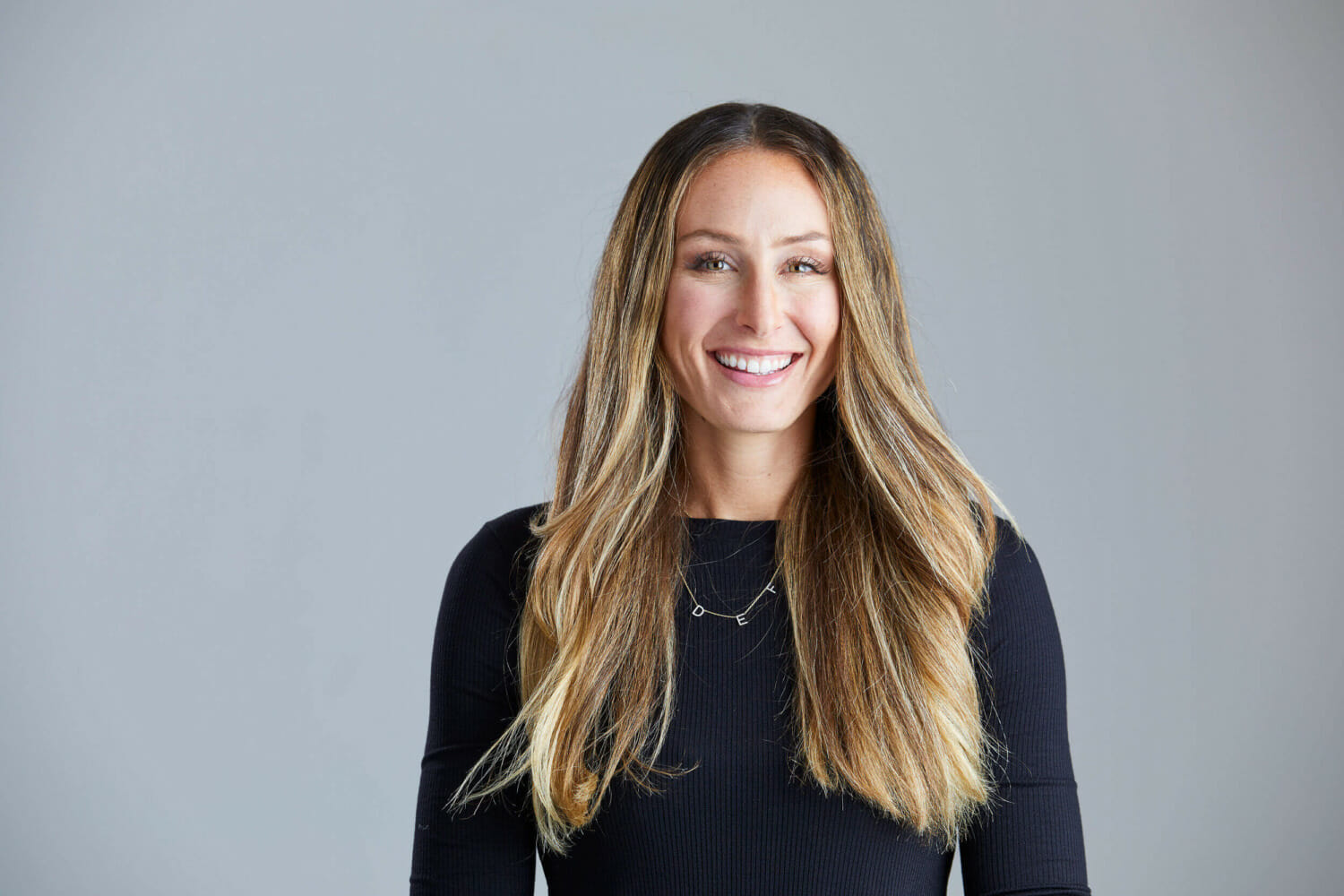 Professional headshots Available at REV Studio Professional headshot ofwoman smiling at camera