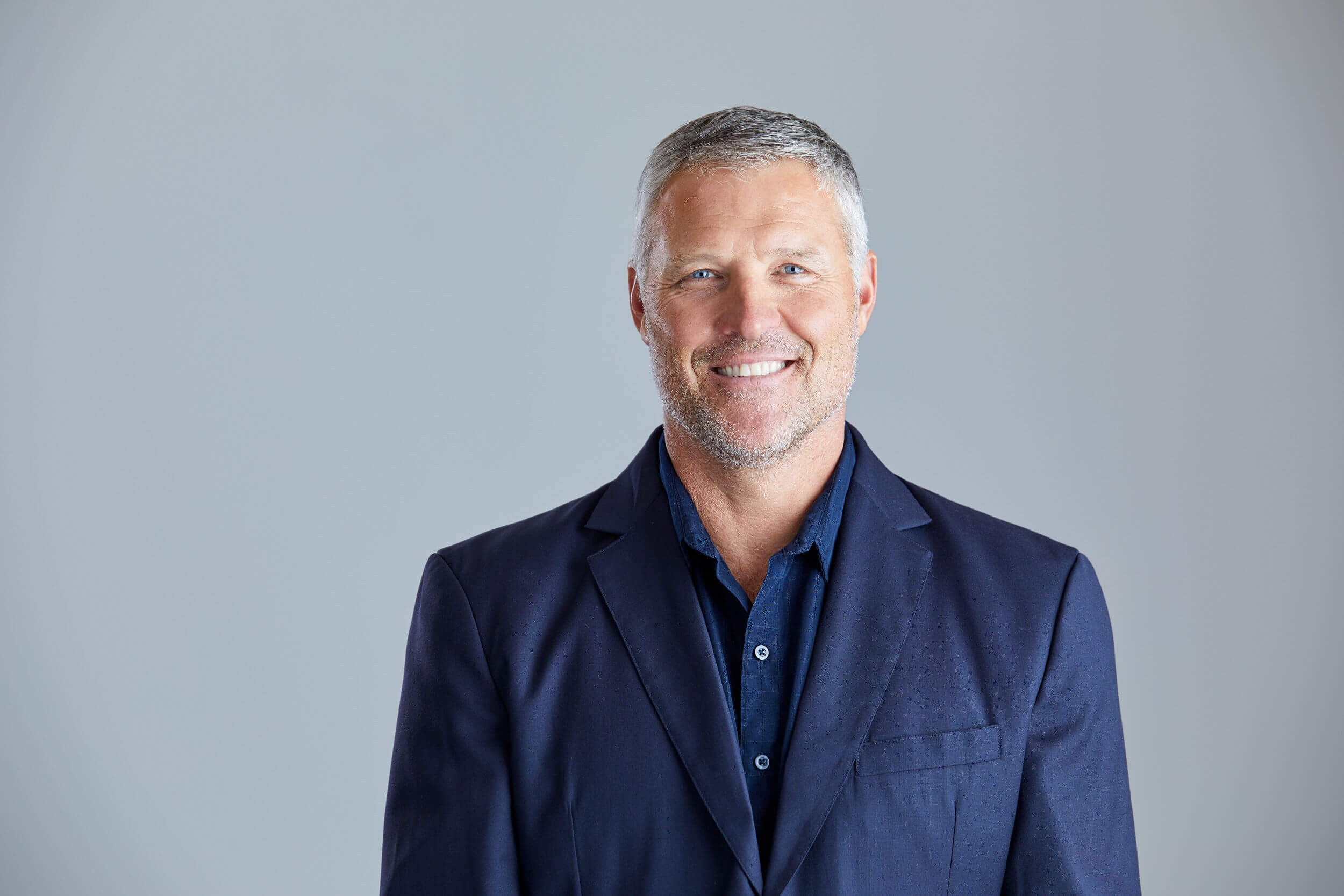 Mark_Strube man looking at camera wearing a suit and smiling