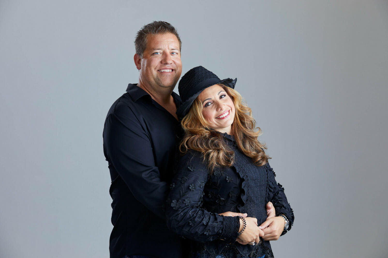 Couples Photoshoots available at REV Studio man hugging woman from behind both looking smiling at camera