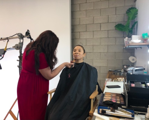 Hair and Make Up Artist on Set Hair and Make Up Artist applying make up to Model