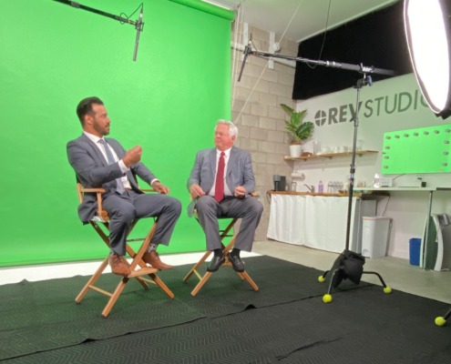 Professional Content Made at REV Studio Two Businessmen in directors chairs in front of green screen on set shooting video content at REV Studio
