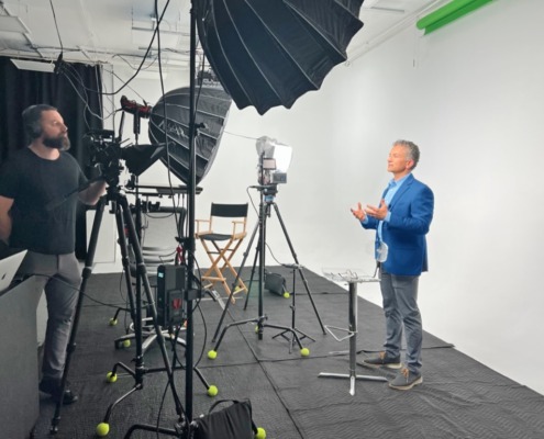 Behind the scenes look at a video shoot at REV Studio Director shooting a video with an actor in front of cyclorama wall