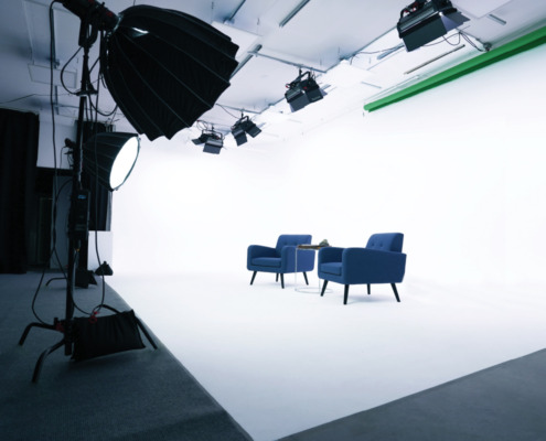 REV Studio is San Diego's Premier Photo and Video Studio Space Extremely Well Lit Cyclorama Wall with Two Chairs on Set